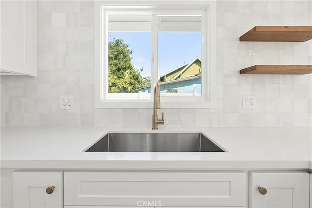 1027 E 10th St, Long Beach, CA 90813 - kitchen with a sink, white cabinets, decorative backsplash, and light countertops