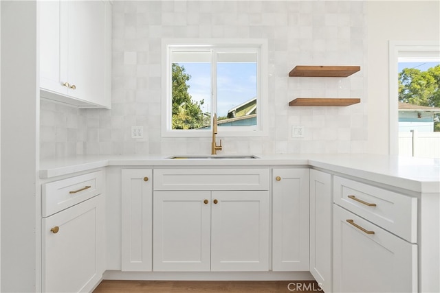 1027 E 10th St, Long Beach, CA 90813 - kitchen featuring a sink, open shelves, decorative backsplash, and white cabinets