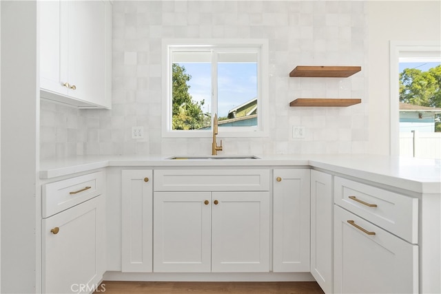 1027 E 10th St, Long Beach, CA 90813 - kitchen featuring open shelves, tasteful backsplash, white cabinets, and light countertops