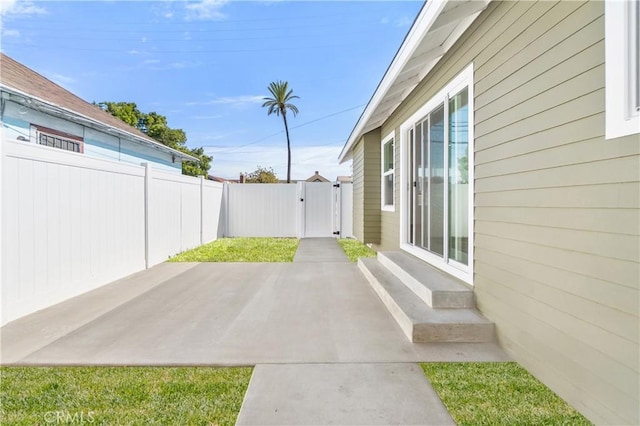 1027 E 10th St, Long Beach, CA 90813 - fenced backyard with a patio area, entry steps, and a gate