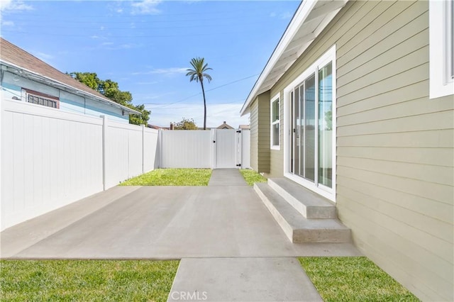 1027 E 10th St, Long Beach, CA 90813 - fenced backyard featuring a patio area, entry steps, and a gate
