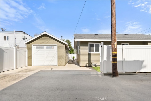 1027 E 10th St, Long Beach, CA 90813 - view of front of home featuring an outbuilding, a detached garage, and driveway
