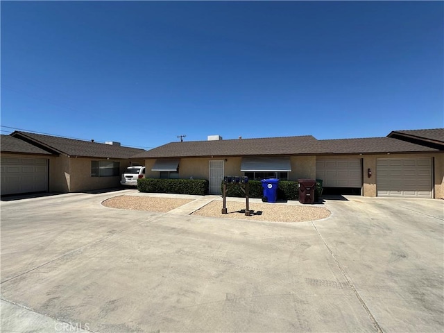 61947 Plaza Rd, Joshua Tree, CA 92252 - single story home featuring stucco siding, driveway, and an attached garage