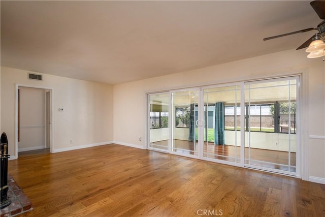 16243 Lisco St, Whittier, CA 90603 - empty room with ceiling fan, plenty of natural light, wood finished floors, and baseboards
