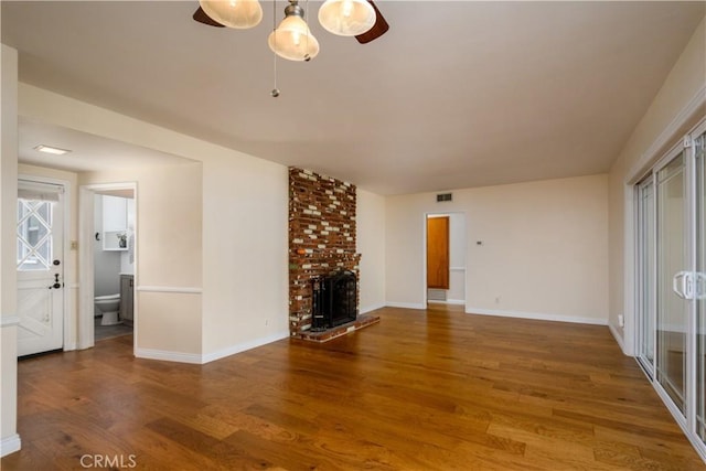 16243 Lisco St, Whittier, CA 90603 - unfurnished living room featuring wood finished floors, baseboards, a brick fireplace, and ceiling fan