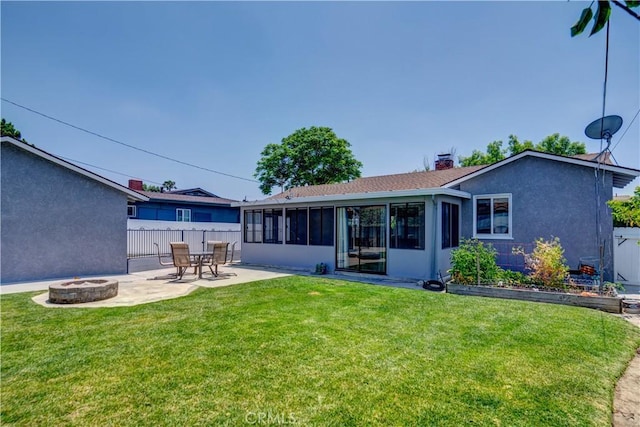 16243 Lisco St, Whittier, CA 90603 - back of property with a fire pit, a sunroom, a patio area, a chimney, and stucco siding
