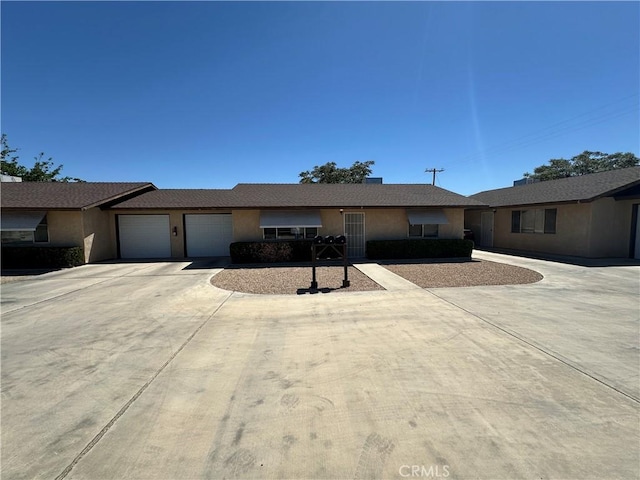61959 Plaza Rd, Joshua Tree, CA 92252 - ranch-style home featuring a garage, concrete driveway, and stucco siding