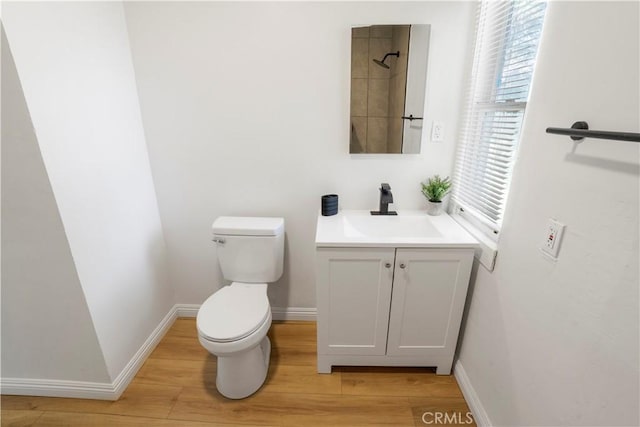 1212 Woodrow Ave, Bakersfield, CA 93308 - bathroom featuring vanity, toilet, wood finished floors, and baseboards
