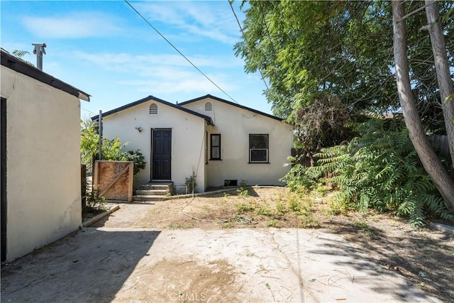 1212 Woodrow Ave, Bakersfield, CA 93308 - rear view of property featuring stucco siding and a patio