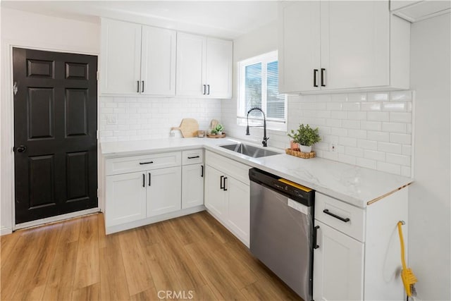 1212 Woodrow Ave, Bakersfield, CA 93308 - kitchen with stainless steel dishwasher, a sink, light wood finished floors, and white cabinetry