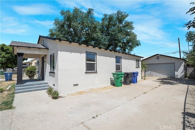 1212 Woodrow Ave, Bakersfield, CA 93308 - view of property exterior featuring crawl space, stucco siding, a garage, and an outbuilding