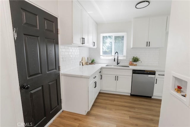 1212 Woodrow Ave, Bakersfield, CA 93308 - kitchen featuring dishwasher, a sink, light countertops, decorative backsplash, and white cabinets