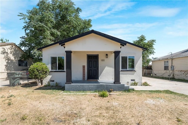 1212 Woodrow Ave, Bakersfield, CA 93308 - bungalow-style house with stucco siding, covered porch, and crawl space