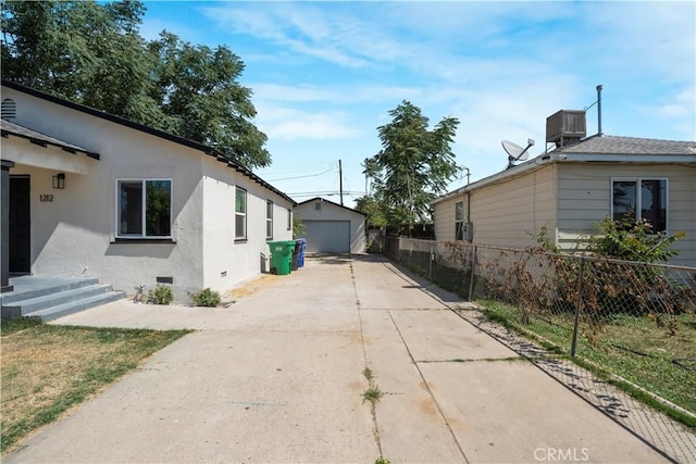 1212 Woodrow Ave, Bakersfield, CA 93308 - view of side of property featuring a garage, crawl space, and stucco siding