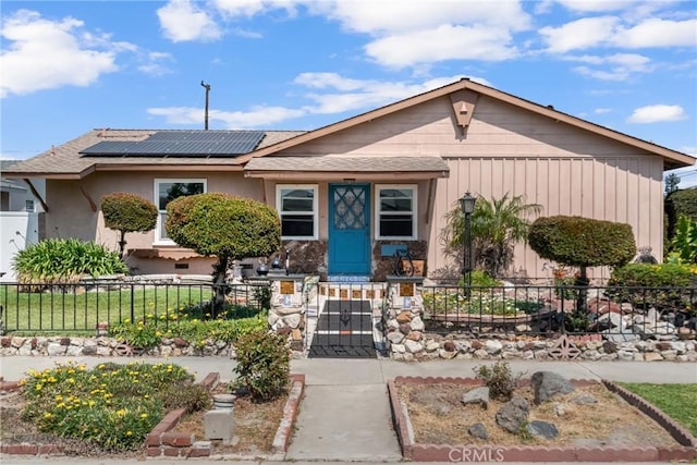 7860 La Fiesta Dr, Buena Park, CA 90620 - single story home featuring solar panels, a fenced front yard, a gate, and stucco siding
