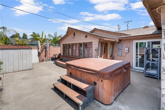 7860 La Fiesta Dr, Buena Park, CA 90620 - back of house with a hot tub, a patio area, a fenced backyard, and stucco siding