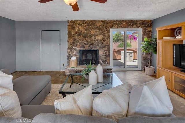 7860 La Fiesta Dr, Buena Park, CA 90620 - living room with a textured ceiling, ceiling fan, and a stone fireplace