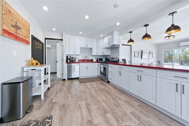 64952 Twentynine Palms Hwy, Joshua Tree, CA 92252 - kitchen featuring appliances with stainless steel finishes, a sink, white cabinetry, light wood-type flooring, and backsplash