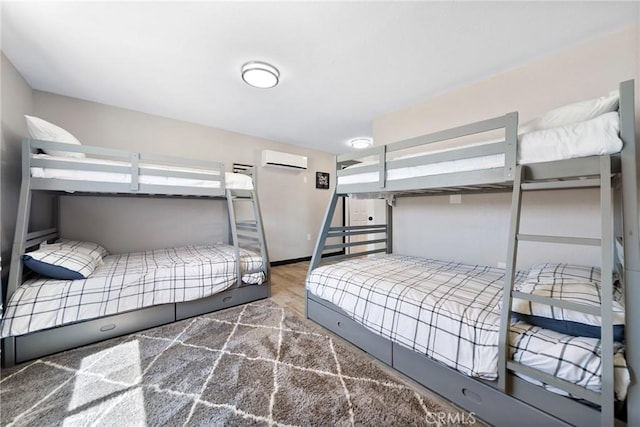 64952 Twentynine Palms Hwy, Joshua Tree, CA 92252 - bedroom with a wall mounted AC and wood finished floors