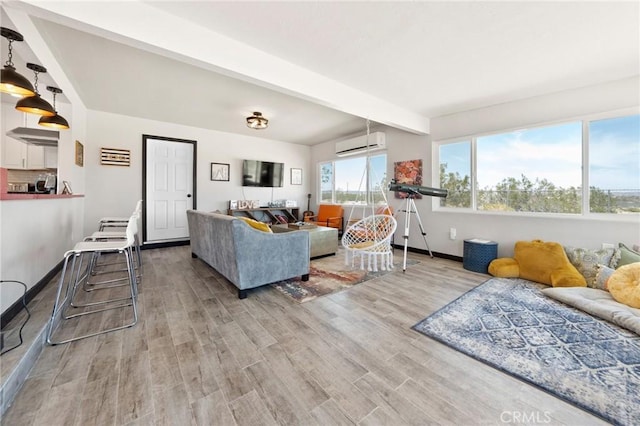 64952 Twentynine Palms Hwy, Joshua Tree, CA 92252 - living area with a wall unit AC, wood finished floors, beamed ceiling, and baseboards