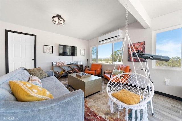 64952 Twentynine Palms Hwy, Joshua Tree, CA 92252 - living area with a wall unit AC, plenty of natural light, wood finished floors, and baseboards