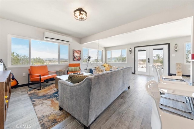 64952 Twentynine Palms Hwy, Joshua Tree, CA 92252 - living area with a wall mounted AC, plenty of natural light, wood finished floors, and french doors