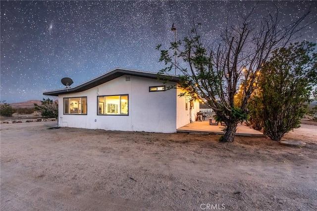 64952 Twentynine Palms Hwy, Joshua Tree, CA 92252 - view of side of property featuring stucco siding and a patio area