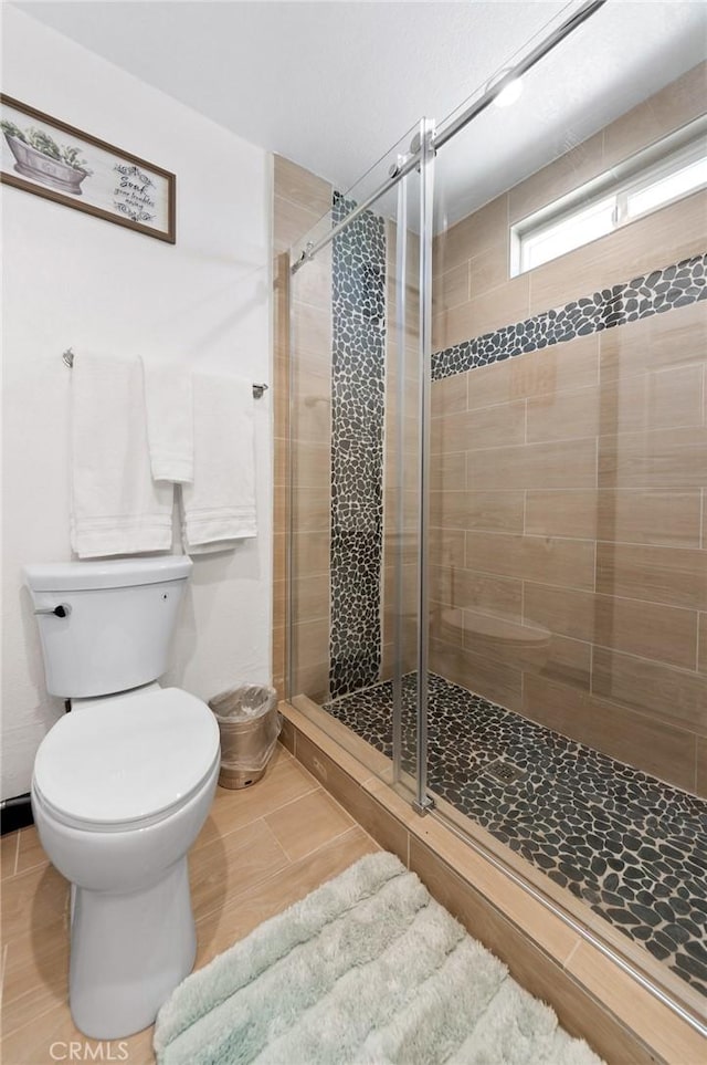 64952 Twentynine Palms Hwy, Joshua Tree, CA 92252 - full bathroom featuring toilet, a shower stall, and tile patterned flooring