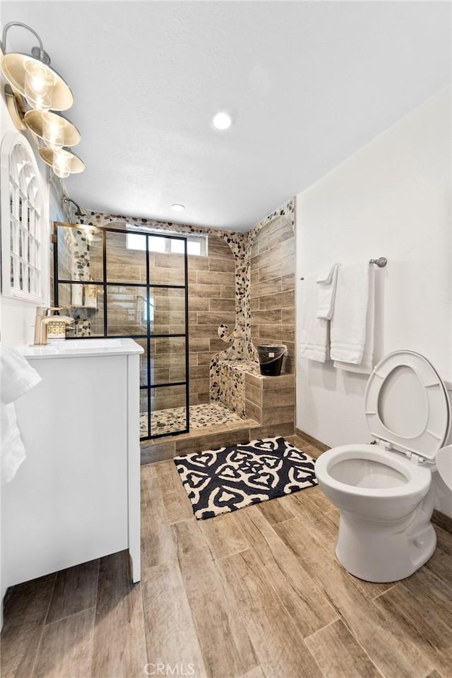 64952 Twentynine Palms Hwy, Joshua Tree, CA 92252 - bathroom with vanity, walk in shower, wood finished floors, toilet, and recessed lighting
