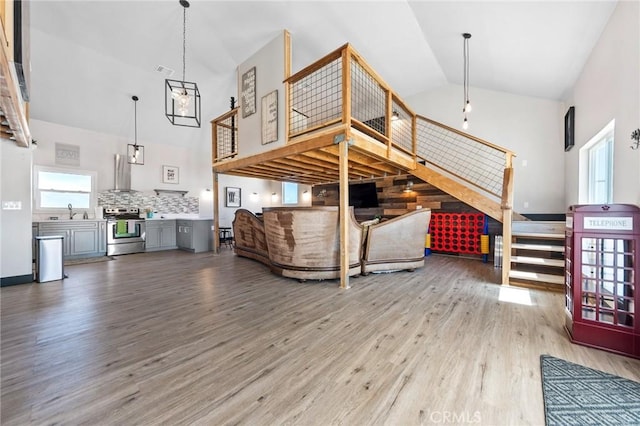 64952 Twentynine Palms Hwy, Joshua Tree, CA 92252 - living area with high vaulted ceiling, wood finished floors, and stairway