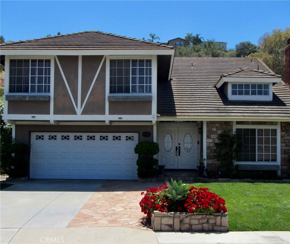 6418 E Lookout Ln, Anaheim Hills, CA 92807 - view of front of property with concrete driveway, an attached garage, stone siding, and stucco siding