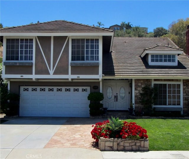 6418 E Lookout Ln, Anaheim Hills, CA 92807 - view of front of property with concrete driveway, an attached garage, stone siding, and stucco siding