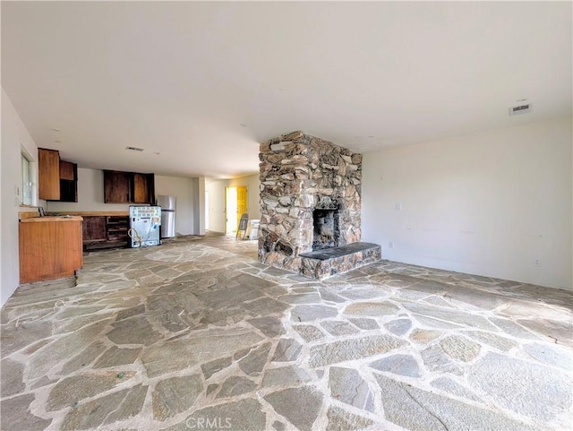 485 State Highway 173, Lake Arrowhead, CA 92352 - unfurnished living room featuring stone floors, a fireplace, and a sink