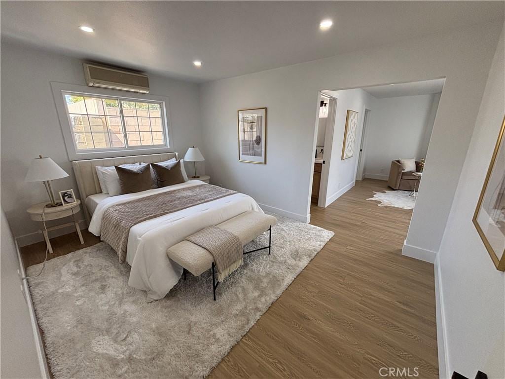 15882 Malm Cir, Huntington Beach, CA 92647 - bedroom featuring a wall unit AC, wood finished floors, and recessed lighting