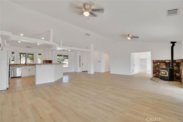 4426 Oil Well Rd, Phelan, CA 92371 - unfurnished living room featuring ceiling fan, a wood stove, vaulted ceiling, light wood-style flooring, and recessed lighting