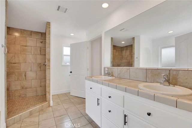 4426 Oil Well Rd, Phelan, CA 92371 - full bathroom featuring tiled shower, double vanity, tile patterned floors, recessed lighting, and tasteful backsplash