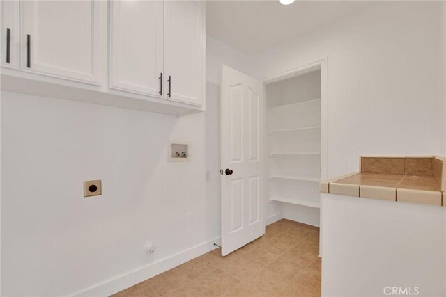 4426 Oil Well Rd, Phelan, CA 92371 - washroom featuring electric dryer hookup, washer hookup, cabinet space, and baseboards