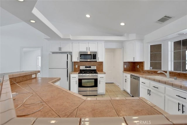 4426 Oil Well Rd, Phelan, CA 92371 - kitchen with appliances with stainless steel finishes, a sink, decorative backsplash, recessed lighting, and white cabinetry