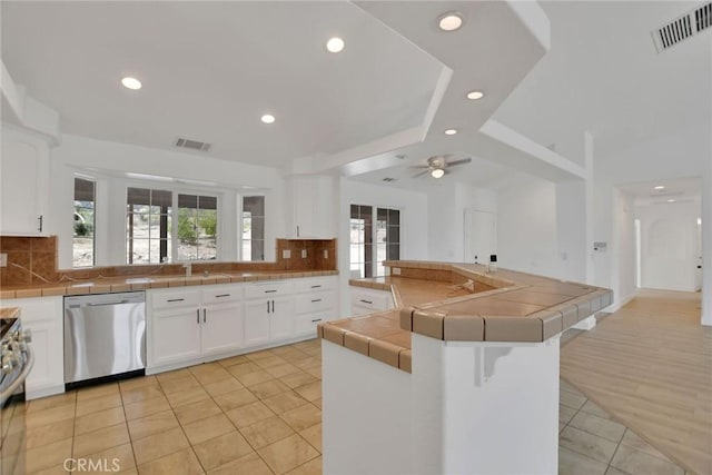 4426 Oil Well Rd, Phelan, CA 92371 - kitchen featuring stainless steel appliances, recessed lighting, tile counters, light tile patterned flooring, and decorative backsplash