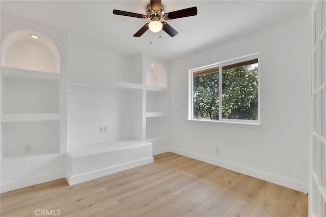 4426 Oil Well Rd, Phelan, CA 92371 - unfurnished room with baseboards, light wood-style floors, built in features, and ceiling fan