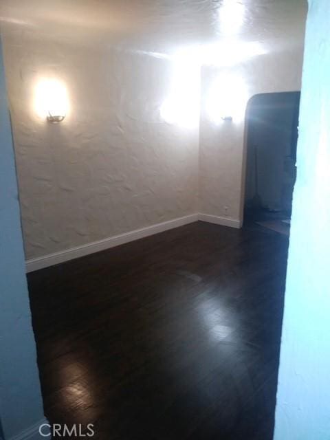 1505 Victoria Dr, Modesto, CA 95351 - unfurnished room featuring baseboards and dark wood-style floors