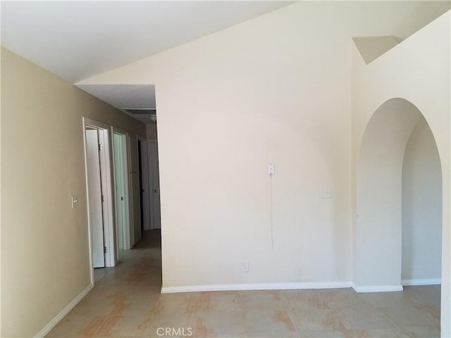 29039 Eveningside Dr, Castaic, CA 91384 - empty room featuring arched walkways, baseboards, and light tile patterned floors