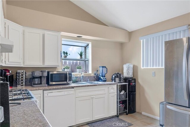 29039 Eveningside Dr, Castaic, CA 91384 - kitchen featuring stainless steel appliances, a sink, white cabinetry, light tile patterned flooring, and exhaust hood