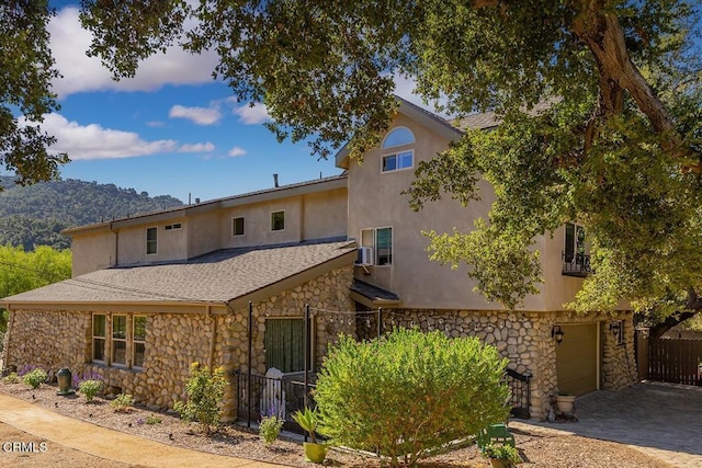 10484 Creek Rd, Oak View, CA 93022 - view of front of home featuring stone siding, driveway, and stucco siding