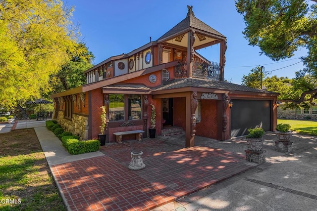 10484 Creek Rd, Oak View, CA 93022 - view of front of house featuring a balcony, stone siding, and driveway