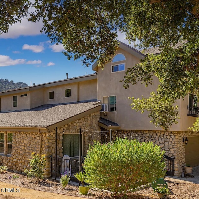 10484 Creek Rd, Oak View, CA 93022 - rear view of house featuring stone siding, stucco siding, and roof with shingles