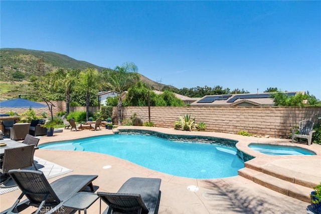 4765 Falconview Ct, Fontana, CA 92336 - view of pool with a mountain view, a patio, a fenced backyard, and an in-ground hot tub