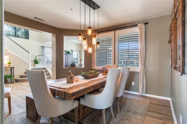 4765 Falconview Ct, Fontana, CA 92336 - dining area with wood finished floors and stairs