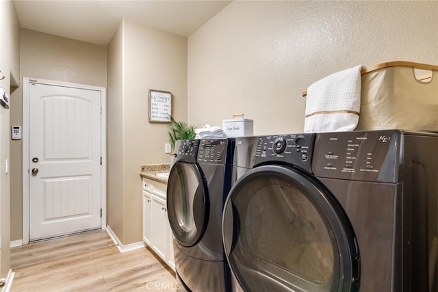 4765 Falconview Ct, Fontana, CA 92336 - laundry area featuring washer and clothes dryer, light wood-style floors, and cabinet space