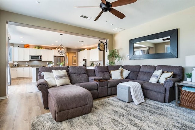 4765 Falconview Ct, Fontana, CA 92336 - living area featuring light wood-style flooring, a ceiling fan, a chandelier, and recessed lighting